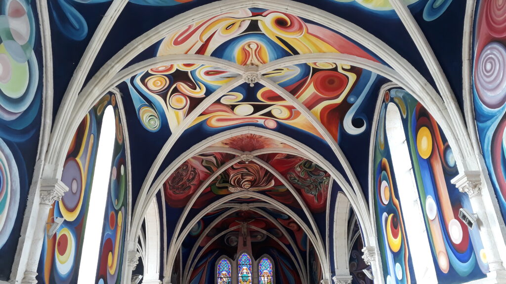 Culture: the colourful ceiling of the church of Le Menoux